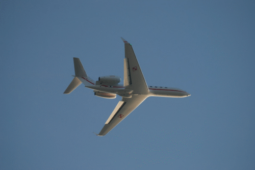 The beautiful underside of a Gulfstream G550 flying in the sky