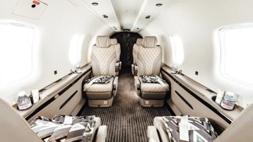 Luxurious cabin interior of the Pilatus PC-12 NGX featuring leather seats, wood accents, and executive layout.